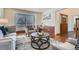 Comfortable living room featuring ample natural light and stylish decor at 4240 S Yukon Way, Lakewood, CO 80235