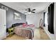 This bedroom has a ceiling fan, grey accent wall, and a window for natural lighting at 1212 S Uvalda St, Aurora, CO 80012
