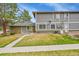 Exterior featuring a well-maintained lawn, mature trees, and a view of the side of the home at 1212 S Uvalda St, Aurora, CO 80012