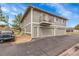 Multi-Gathering home with gray siding, multiple garages, and a small balcony at 1212 S Uvalda St, Aurora, CO 80012