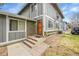 Charming exterior showcasing the front door, brick accents, and well-maintained landscaping at 1212 S Uvalda St, Aurora, CO 80012