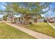 Inviting exterior with a well-manicured lawn, mature trees, and cozy front patio at 1212 S Uvalda St, Aurora, CO 80012