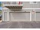 Garage doors, numbered 1214 and 1212, beneath a balcony, with 'No Parking Fire Lane' signage at 1212 S Uvalda St, Aurora, CO 80012