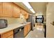 Efficient kitchen features wooden cabinets, tile floors, stainless appliances, and eat-in area at 1212 S Uvalda St, Aurora, CO 80012