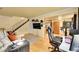 Cozy living room with hardwood floors, staircase, and modern entertainment setup at 1212 S Uvalda St, Aurora, CO 80012