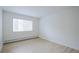 Clean, empty bedroom with a large window providing natural light and new wood flooring at 3450 S Poplar St # 307, Denver, CO 80224