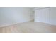 Bright and airy bedroom with light wood floors and a spacious closet with sliding doors at 3450 S Poplar St # 307, Denver, CO 80224