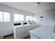 Well-lit laundry room featuring modern washing machines, folding table, and bright windows at 3450 S Poplar St # 307, Denver, CO 80224