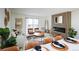 Open-concept living room features cozy seating, fireplace, and adjacent dining area with natural light at 3450 S Poplar St # 307, Denver, CO 80224