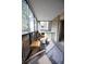 Enclosed sunroom with wicker seating, desk space, and views of the surrounding landscape at 3450 S Poplar St # 307, Denver, CO 80224