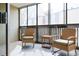 Relaxing sunroom with large windows, woven chairs, and neutral color scheme offers a tranquil retreat at 3450 S Poplar St # 307, Denver, CO 80224