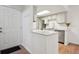 Bright kitchen with white cabinets, stainless steel appliances, breakfast bar, and hardwood floors at 921 S Zeno Way # 201, Aurora, CO 80017