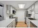 Kitchen featuring stainless appliances, white cabinets, countertop, and skylight at 921 S Zeno Way # 201, Aurora, CO 80017