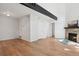 Bright living room with hardwood floors, stone fireplace, and a vaulted ceiling beam at 921 S Zeno Way # 201, Aurora, CO 80017