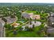 Beautiful aerial view of a community park, school, and pond surrounded by lush greenery and neighborhood homes at 12625 W 66Th Cir, Arvada, CO 80004