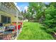 Lush backyard features a patio area with an outdoor kitchen and a well-manicured lawn at 12625 W 66Th Cir, Arvada, CO 80004