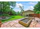 Large backyard featuring a patio, planter boxes, and mature trees at 12625 W 66Th Cir, Arvada, CO 80004
