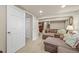 Basement living area with carpet, large sofa, and view to additional room at 12625 W 66Th Cir, Arvada, CO 80004