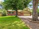 Charming home with a lush front lawn and mature trees providing ample shade at 12625 W 66Th Cir, Arvada, CO 80004