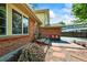 Home featuring a brick facade, a cozy outdoor seating area, and a well-manicured garden at 12625 W 66Th Cir, Arvada, CO 80004