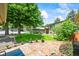 Charming home with a lush green lawn, mature tree, and inviting stone walkway leading to the front door at 12625 W 66Th Cir, Arvada, CO 80004