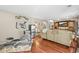 Open living space featuring an elliptical trainer, sleek hardwood floors, and entertainment center at 12625 W 66Th Cir, Arvada, CO 80004