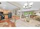 Open concept living area showcasing hardwood floors and seamless flow to the kitchen at 12625 W 66Th Cir, Arvada, CO 80004