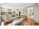 Comfortable living room featuring hardwood floors, fireplace, and view into adjacent bathroom at 12625 W 66Th Cir, Arvada, CO 80004