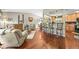 Inviting living space with hardwood floors and an open layout leading to the kitchen at 12625 W 66Th Cir, Arvada, CO 80004