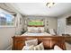 Serene main bedroom featuring a plush bed, decorative pillows, and natural light from large windows at 12625 W 66Th Cir, Arvada, CO 80004