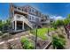 Backyard with deck, well-maintained lawn, and garden area at 23957 E Rocky Top Ave, Aurora, CO 80016