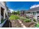 Fenced backyard, featuring a garden area, lawn, and landscaping, is ideal for outdoor enjoyment at 23957 E Rocky Top Ave, Aurora, CO 80016