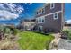 Nice-sized backyard with healthy green lawn and a home exterior with plenty of windows at 23957 E Rocky Top Ave, Aurora, CO 80016