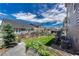 Serene backyard features lush lawn, garden beds, and tasteful landscaping with a multi-home view at 23957 E Rocky Top Ave, Aurora, CO 80016