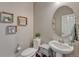 Powder room featuring pedestal sink, modern fixtures, and decor at 23957 E Rocky Top Ave, Aurora, CO 80016
