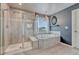 Well-appointed bathroom featuring a glass-enclosed shower and soaking tub, perfect for relaxation at 23957 E Rocky Top Ave, Aurora, CO 80016