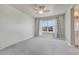 Light-filled bedroom with a ceiling fan, carpet flooring, and a window with curtains, ready for personalization at 23957 E Rocky Top Ave, Aurora, CO 80016