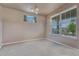Empty bedroom with carpet flooring, neutral walls, a modern light fixture and a large window at 23957 E Rocky Top Ave, Aurora, CO 80016