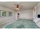 Bright bedroom features neutral walls, carpet, a ceiling fan, and a doorway to an adjoining room at 23957 E Rocky Top Ave, Aurora, CO 80016