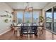 Elegant dining room featuring modern lighting fixture, hardwood floors, and plenty of natural light at 23957 E Rocky Top Ave, Aurora, CO 80016