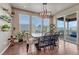 Dining room featuring hardwood floors, natural light, and a modern chandelier at 23957 E Rocky Top Ave, Aurora, CO 80016
