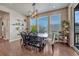 Dining room area featuring large windows, a modern chandelier, and a table with seating for six at 23957 E Rocky Top Ave, Aurora, CO 80016