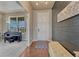 Welcoming entryway with modern decor, hardwood flooring, and a view into a bright living space at 23957 E Rocky Top Ave, Aurora, CO 80016