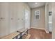 Cozy entryway features bench seating, coat hooks, and a bright window at 23957 E Rocky Top Ave, Aurora, CO 80016