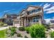 Charming two-story home with stone accents, well-manicured landscaping, and inviting front porch at 23957 E Rocky Top Ave, Aurora, CO 80016