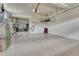 Spacious garage with epoxy floors, overhead storage, and ample space for parking and storage at 23957 E Rocky Top Ave, Aurora, CO 80016