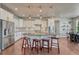 Modern kitchen featuring an island with seating, stainless steel appliances, and stylish pendant lighting at 23957 E Rocky Top Ave, Aurora, CO 80016