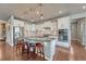 Modern kitchen boasts white cabinets, stainless appliances, and a spacious center island at 23957 E Rocky Top Ave, Aurora, CO 80016