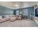 Comfortable living room with neutral tones, a plush sectional sofa, and plenty of natural light at 23957 E Rocky Top Ave, Aurora, CO 80016