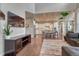 Open-concept living room showcases hardwood floors and transitions into a modern kitchen with a large island at 23957 E Rocky Top Ave, Aurora, CO 80016